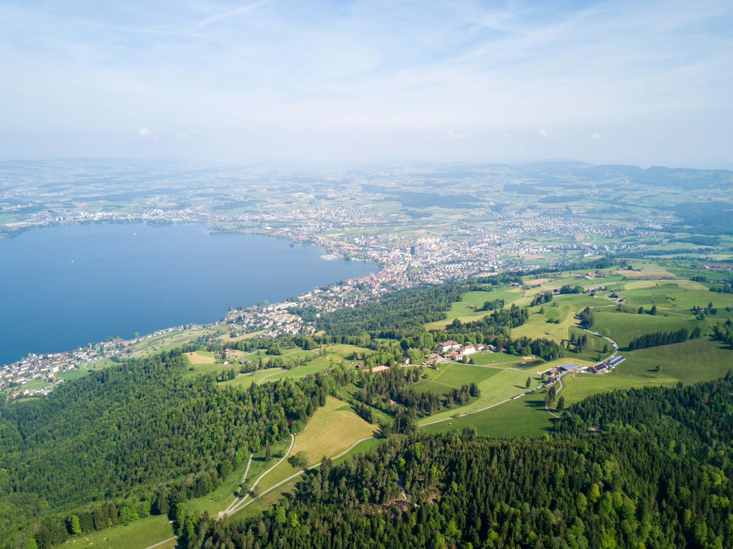 Panoramic view of Zug, Switzerland — lake, old town, and mountains